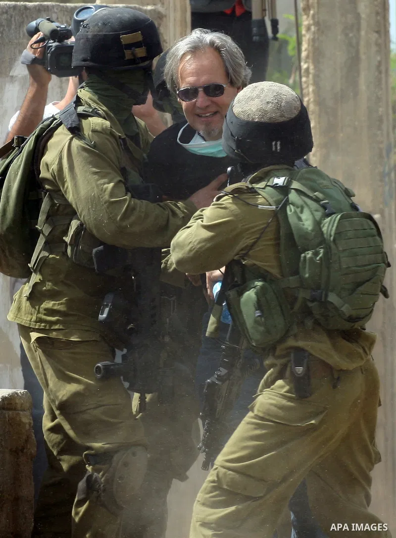 Israeli soldiers arrest an American peace activist during clashes following a demonstration against the expropriation of Palestinian land by Israel in the village of Kafr Qadum in the occupied West Bank on October 5, 201...