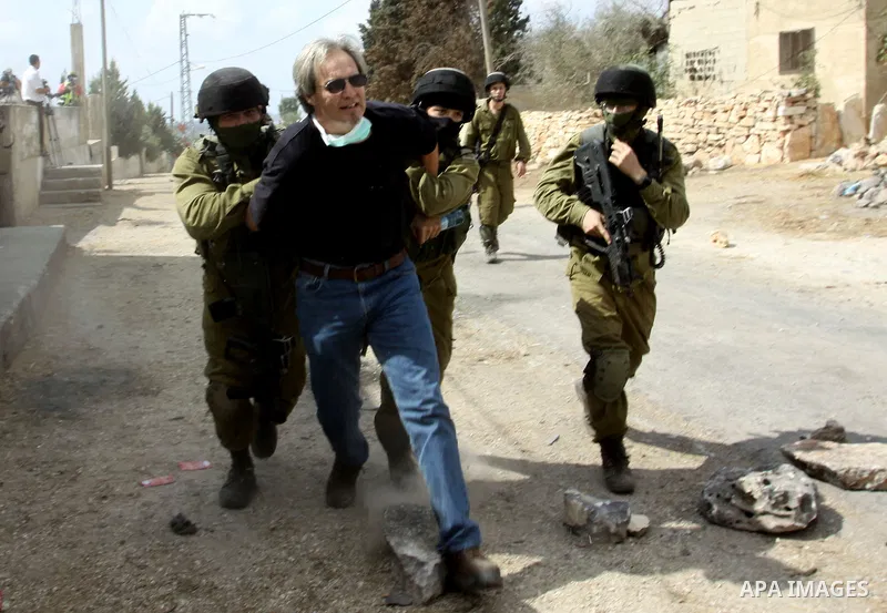 Israeli soldiers arrest an American peace activist during clashes following a demonstration against the expropriation of Palestinian land by Israel in the village of Kafr Qadum in the occupied West Bank on October 5, 201...