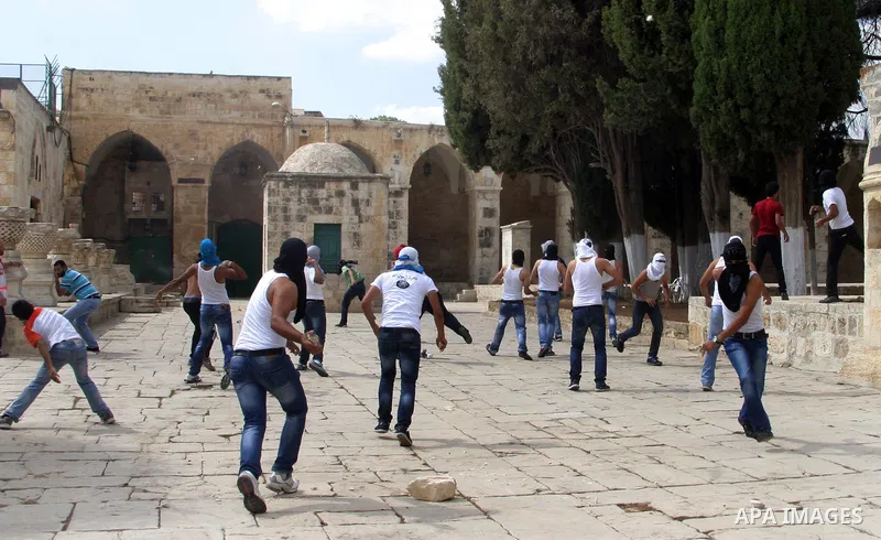 Palestinian worshippers throw stones toward Israeli forces, not pictured, during clashes at the Al Aqsa Mosque compound, known by the Jews as the Temple Mount, in Jerusalem's Old City, Friday, Oct. 5, 2012. Earlier this...