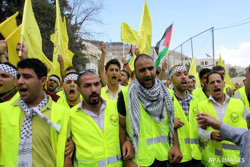Palestinian supporters of the Fatah party wave the party's flags during a campaign rally for its candidates running in the local council elections in the West Bank city of Nablus on October 6, 2012.. Photo by Nedal Eshta...