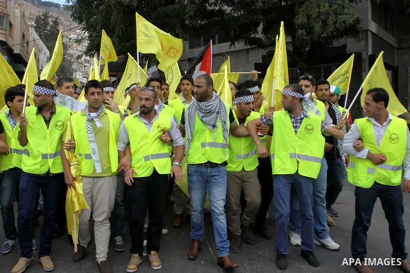 Palestinian supporters of the Fatah party wave the party's flags during a campaign rally for its candidates running in the local council elections in the West Bank city of Nablus on October 6, 2012.. Photo by Nedal Eshta...