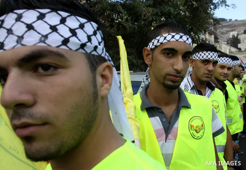 Palestinian supporters of the Fatah party wave the party's flags during a campaign rally for its candidates running in the local council elections in the West Bank city of Nablus on October 6, 2012.. Photo by Nedal Eshta...