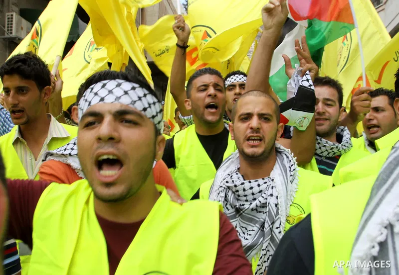 Palestinian supporters of the Fatah party wave the party's flags during a campaign rally for its candidates running in the local council elections in the West Bank city of Nablus on October 6, 2012.. Photo by Nedal Eshta...