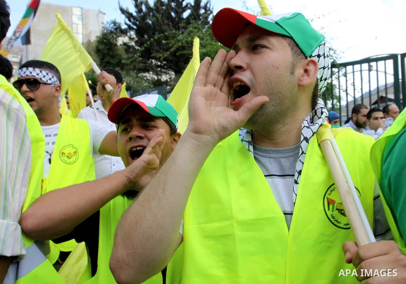 Palestinian supporters of the Fatah party wave the party's flags during a campaign rally for its candidates running in the local council elections in the West Bank city of Nablus on October 6, 2012.. Photo by Nedal Eshta...