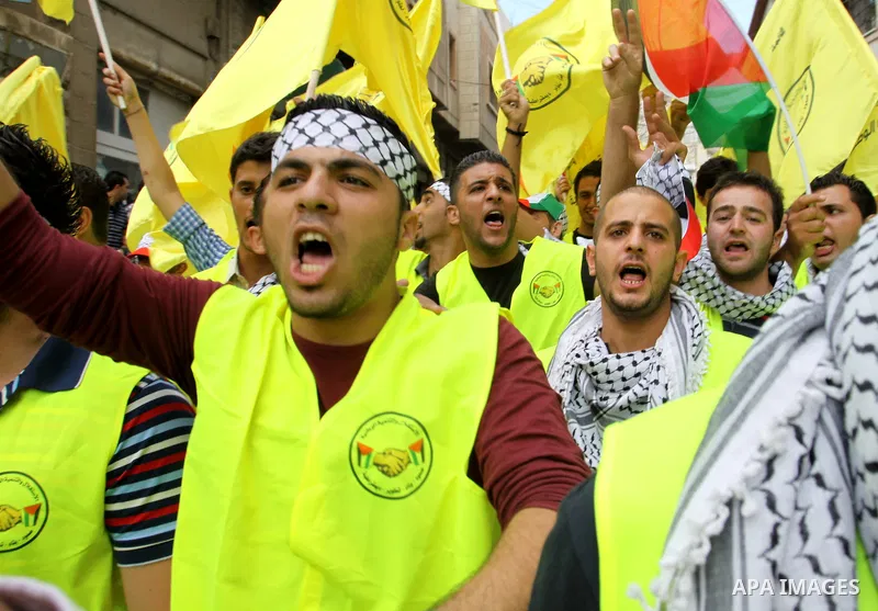 Palestinian supporters of the Fatah party wave the party's flags during a campaign rally for its candidates running in the local council elections in the West Bank city of Nablus on October 6, 2012.. Photo by Nedal Eshta...