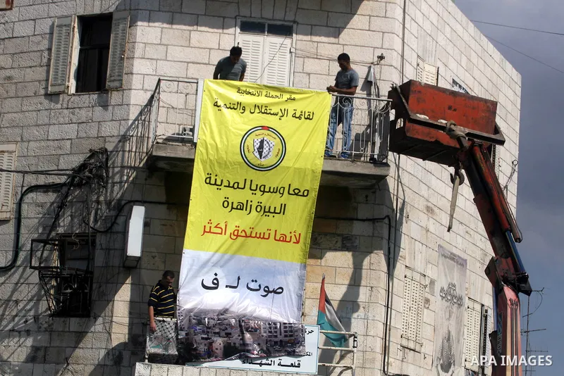 Palestinian supporters of the Fatah party wave the party's flags during a campaign rally for its candidates running in the local council elections in the West Bank city of Ramallah on the first day of campaigning for the...