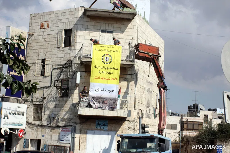 Palestinian supporters of the Fatah party wave the party's flags during a campaign rally for its candidates running in the local council elections in the West Bank city of Ramallah on the first day of campaigning for the...