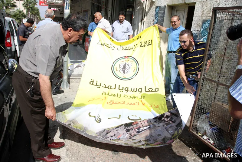 Palestinian supporters of the Fatah party wave the party's flags during a campaign rally for its candidates running in the local council elections in the West Bank city of Ramallah on the first day of campaigning for the...