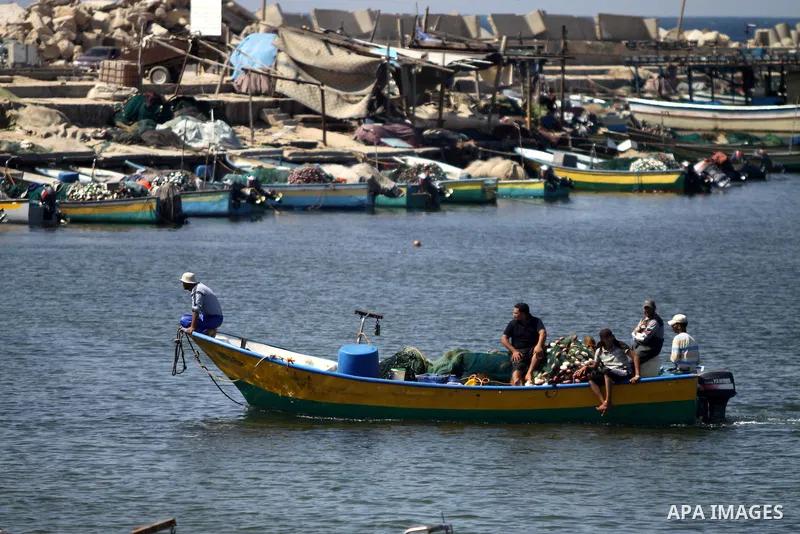 Palestinian fishermen work at Gaza seaport during the preparation to receive the ship Estelle which coming from naples, in Gaza city on October 07, 2012. The Estelle, the latest ship to try to break Israel's blockade on...