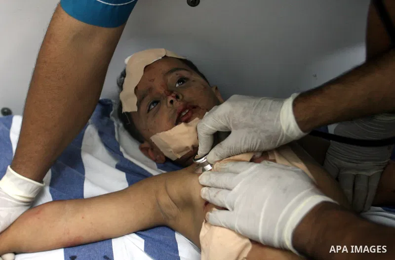 Medics treat a wounded Palestinian boy in a hospital following an Israeli air strike in Rafah camp in the southern Gaza Strip October 7, 2012. A missile fired by an Israeli aircraft hit and wounded two Palestinian milita...