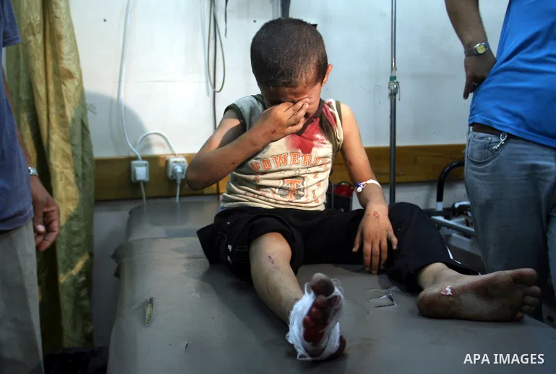 Medics treat a wounded Palestinian boy in a hospital following an Israeli air strike in Rafah camp in the southern Gaza Strip October 7, 2012. A missile fired by an Israeli aircraft hit and wounded two Palestinian milita...
