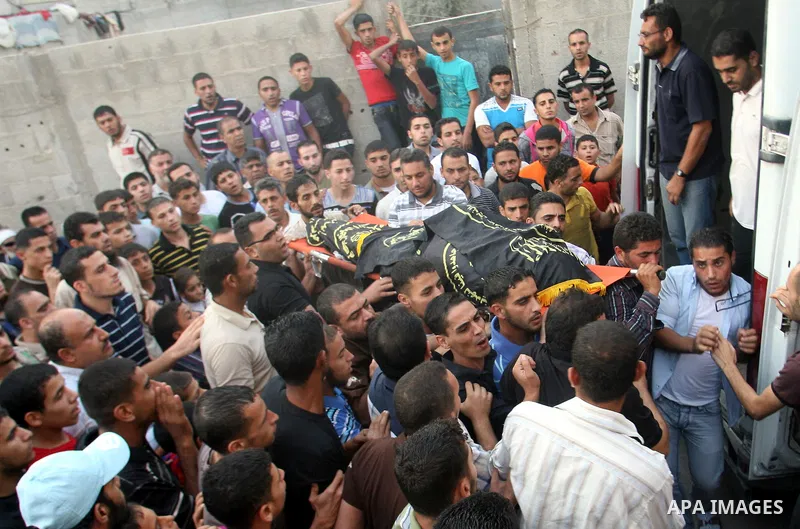 Palestinians carry the body of Abdullah Maqawai during his funeral in Rafah in the southern Gaza Strip on October 8, 2012 after he died of his wounds sustained in an Israeli air strike. Gaza's ruling Hamas movement and t...