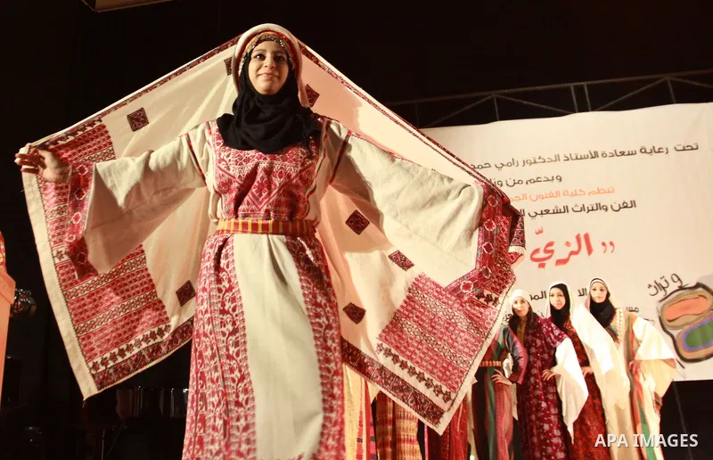Palestinian girls wear folk costumes during a traditional costumes show in the West Bank city of Nablus, Oct. 09, 2012. Traditional Palestinian costumes reflected a woman's economic and marital status and her town or dis...