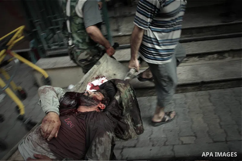 A Free Syrian fighter is brought to the Dar al-Shifa hospital in the northern city of Aleppo to be treated for his wounds on September 27, 2012, as fighting in Syria's second largest city between rebel forces and governm...