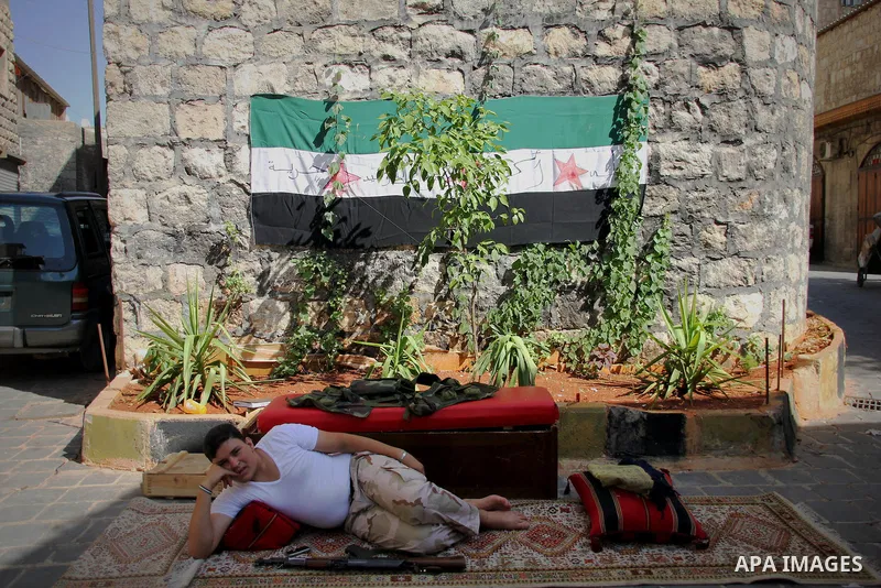 A Free Syrian army fighter takes rest in the street in the old city of Aleppo, September 03 2012. Photo by Ahmed Deeb