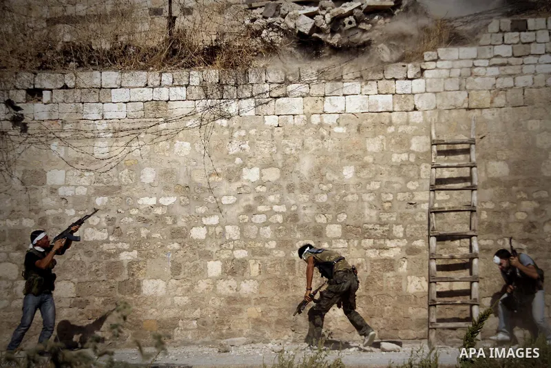 Free Syrian Army take position during heavy clashes with Syrian government forces , in the Old Town of Aleppo, September 07, 2012, to retake control of the large Hanano army base in Aleppo. Photo by Ahmed Deeb