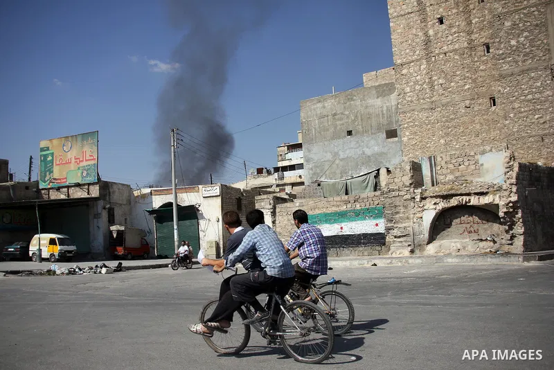 Smoke billows from a burning houses in the city of Aleppo after the area was shelled by Syrian regime forces on September 09 2012. Forces loyal to President Bashar al-Assad shelled rebel-held areas across Syria as fierce...