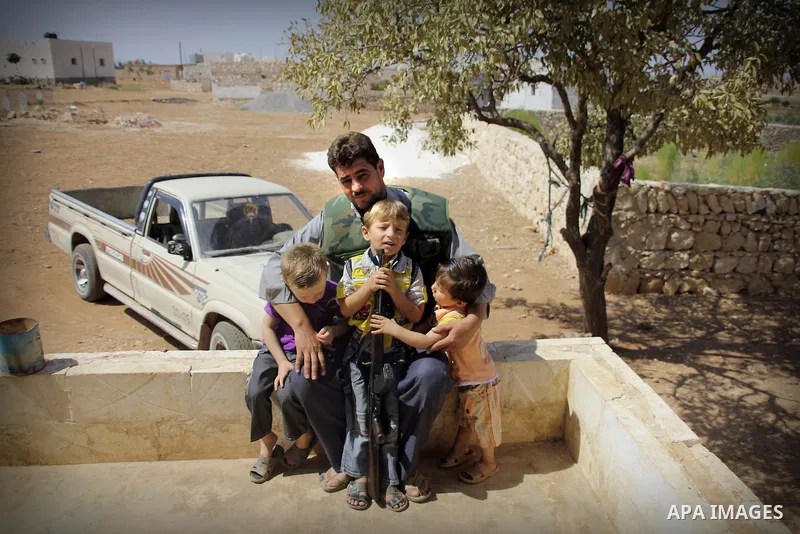 Abu Muhamed, A free Syrian army fighter with his kids before join the FSA Army in the city of Aleppo, September 11, 2012. Photo by Ahmed Deeb