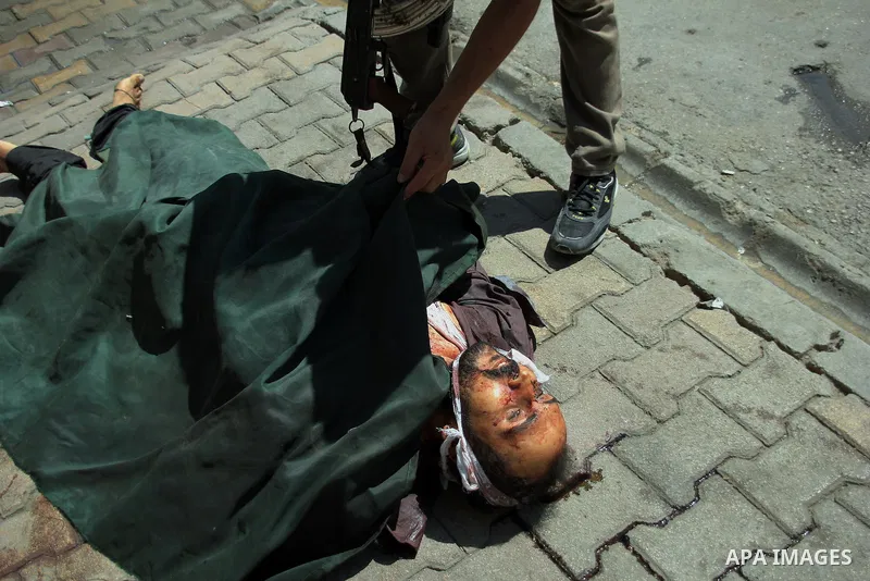 A dead Syrian man in the city of Aleppo after the area was shelled by Syrian regime forces on September 12 2012. Forces loyal to President Bashar al-Assad shelled rebel-held areas across Syria as fierce clashes were repo...