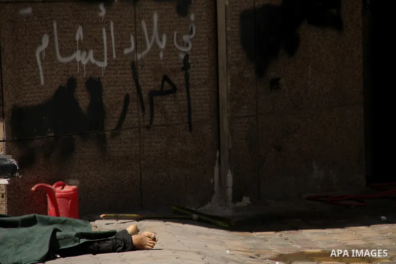 A dead Syrian man in the city of Aleppo after the area was shelled by Syrian regime forces on September 12 2012. Forces loyal to President Bashar al-Assad shelled rebel-held areas across Syria as fierce clashes were repo...
