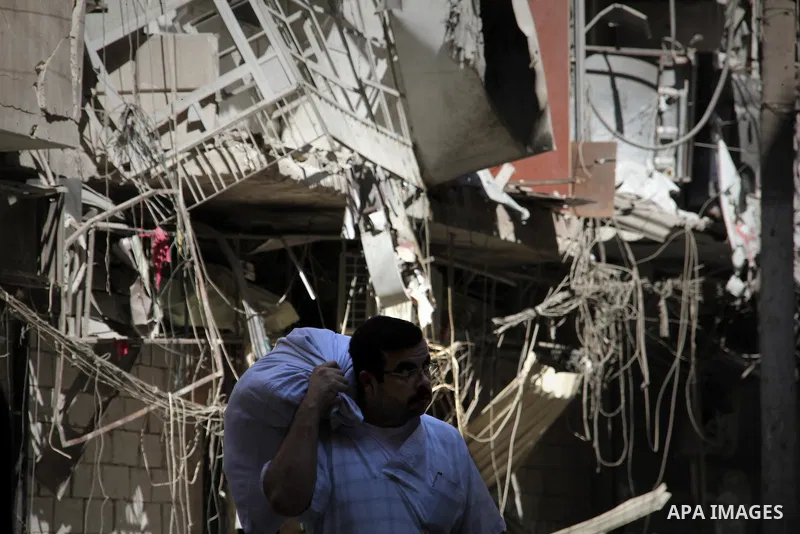 Syrians inspect damages in the old city of Aleppo after the area was shelled by Syrian regime forces on September 12, 2012. Forces loyal to President Bashar al-Assad shelled rebel-held areas across Syria as fierce clashe...