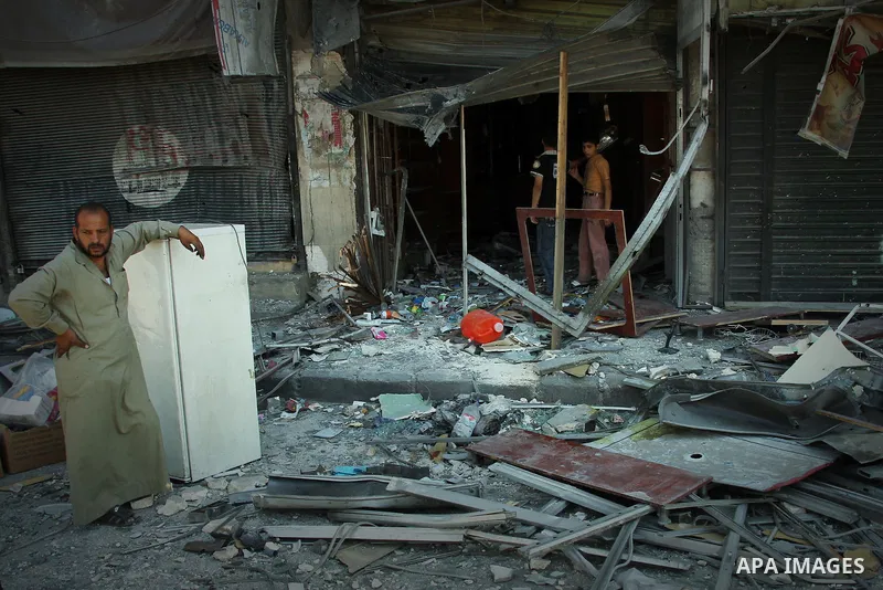 Syrians inspect damages in the old city of Aleppo after the area was shelled by Syrian regime forces on September 12, 2012. Forces loyal to President Bashar al-Assad shelled rebel-held areas across Syria as fierce clashe...