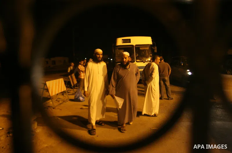 Palestinian pilgrims sit in buses as they wait to cross the Rafah border crossing into Egypt , in the southern Gaza Strip town of Rafah on Oct. 09, 2012 . Hundreds of Palestinian pilgrims crossed into Egypt on their way...