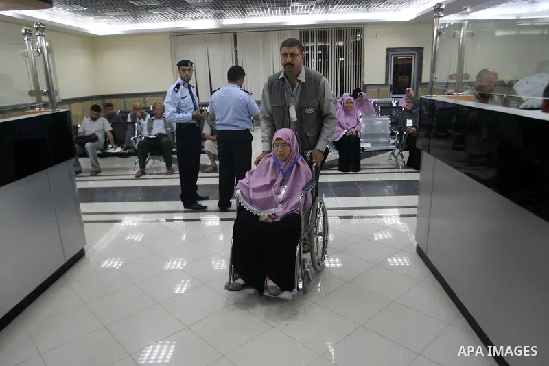Palestinian pilgrims wait at a hall after they cross the Rafah border crossing into Gaza Strip, in the southern Gaza strip town of Rafah on Oct. 09, 2012. Hundreds of Palestinian pilgrims will cross into Gaza Strip on th...