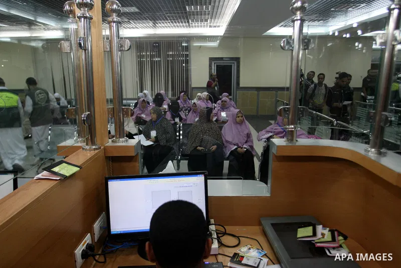 Palestinian pilgrims wait at a hall after they cross the Rafah border crossing into Gaza Strip, in the southern Gaza strip town of Rafah on Oct. 09, 2012. Hundreds of Palestinian pilgrims will cross into Gaza Strip on th...