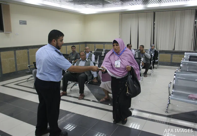 Palestinian pilgrims wait at a hall after they cross the Rafah border crossing into Gaza Strip, in the southern Gaza strip town of Rafah on Oct. 09, 2012. Hundreds of Palestinian pilgrims will cross into Gaza Strip on th...