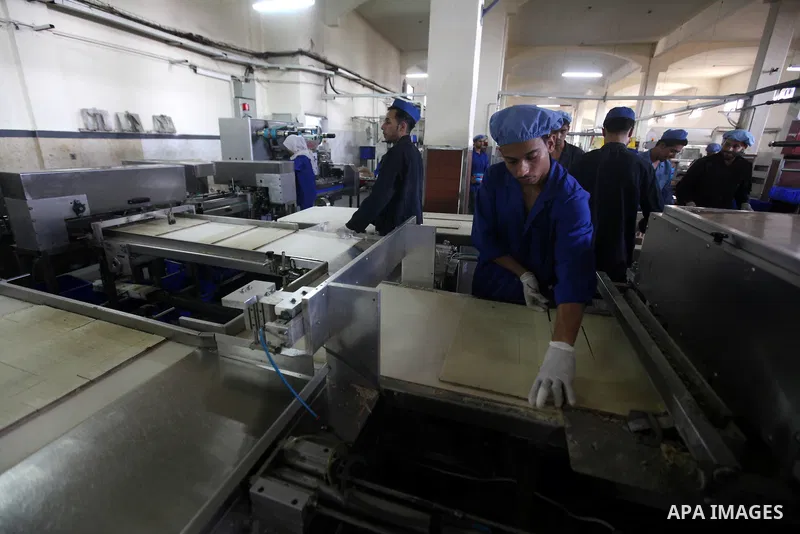 Palestinian workers quality control biscuits at the al-Awda factory in Deir al-Balah, in the central Gaza strip, on October 10, 2012. The World Food Program (WFP) will export the biscuits to United Nation run schools in...