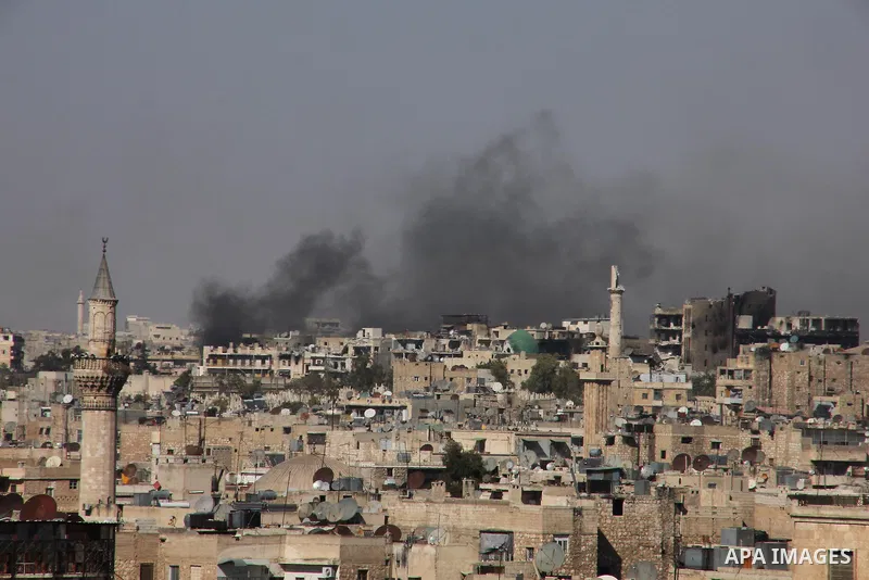 Smoke billows from a burning houses in al-Sha'ar neighborhood in the old city of Aleppo after the area was shelled by Syrian regime forces on September 12 2012. Forces loyal to President Bashar al-Assad shelled rebel-hel...