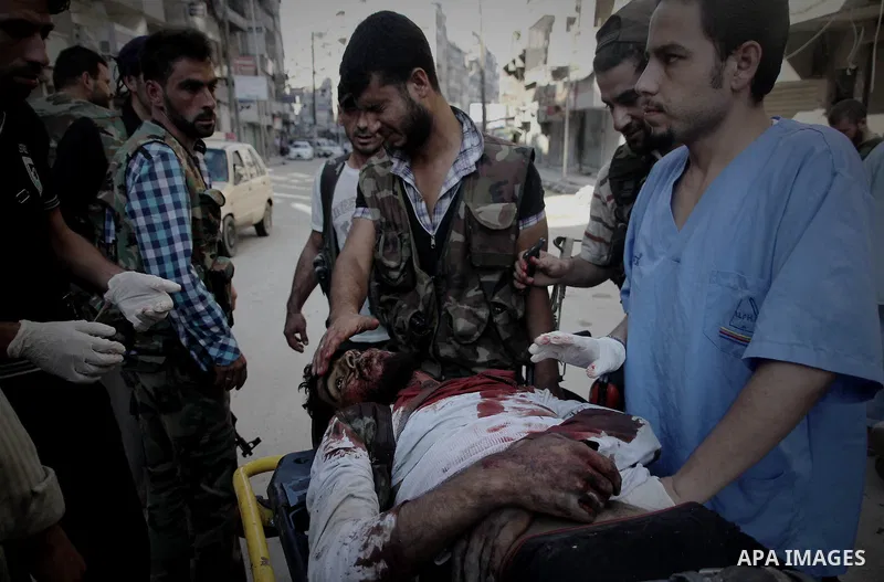 A Free Syrian fighter is brought to the Dar al-Shifa hospital in the northern city of Aleppo to be treated for his wounds on September 27, 2012, as fighting in Syria's second largest city between rebel forces and governm...