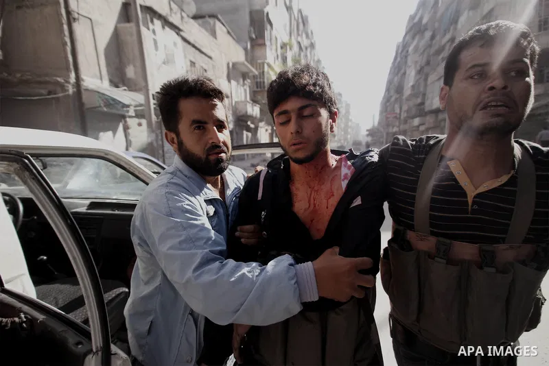 A Free Syrian fighter is brought to the Dar al-Shifa hospital in the northern city of Aleppo to be treated for his wounds on September 27, 2012, as fighting in Syria's second largest city between rebel forces and governm...