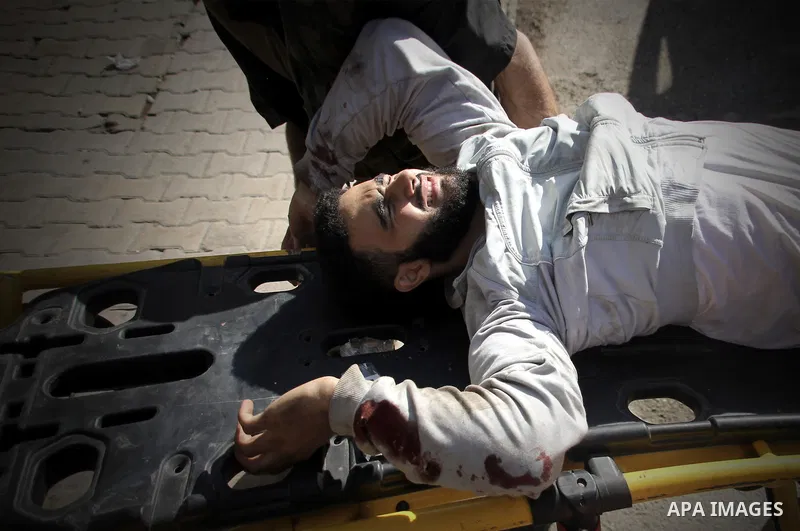 A Free Syrian fighter is brought to the Dar al-Shifa hospital in the northern city of Aleppo to be treated for his wounds on September 27, 2012, as fighting in Syria's second largest city between rebel forces and governm...