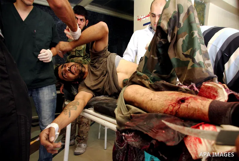 A Free Syrian fighter is brought to the Dar al-Shifa hospital in the northern city of Aleppo to be treated for his wounds on September 27, 2012, as fighting in Syria's second largest city between rebel forces and governm...