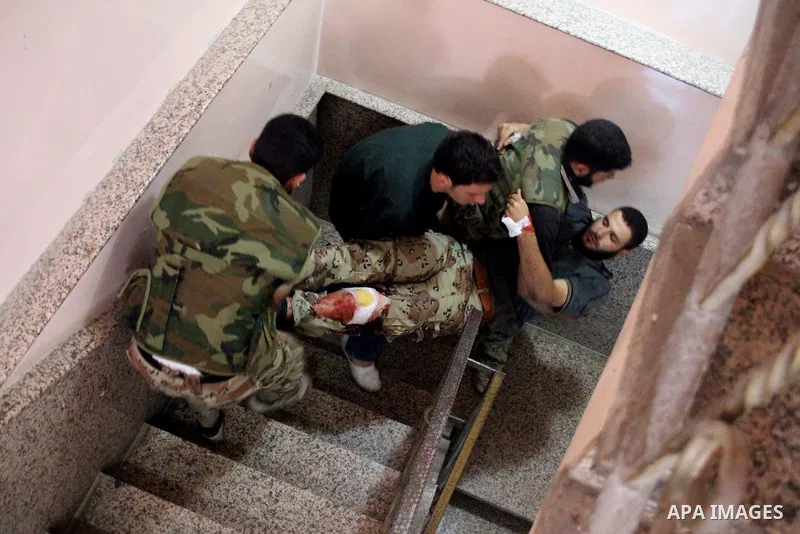 A Free Syrian fighter is brought to the Dar al-Shifa hospital in the northern city of Aleppo to be treated for his wounds on September 27, 2012, as fighting in Syria's second largest city between rebel forces and governm...