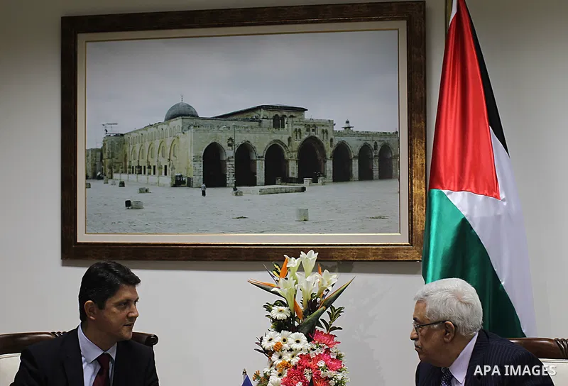 Palestinian President Mahmoud Abbas (R) meets with Romanian Foreign Minister Titus Corlatean (L) in the West Bank city of Ramallah, Oct. 10, 2011. Corlatean is on an official visit to the region. Photo by Issam Rimawi