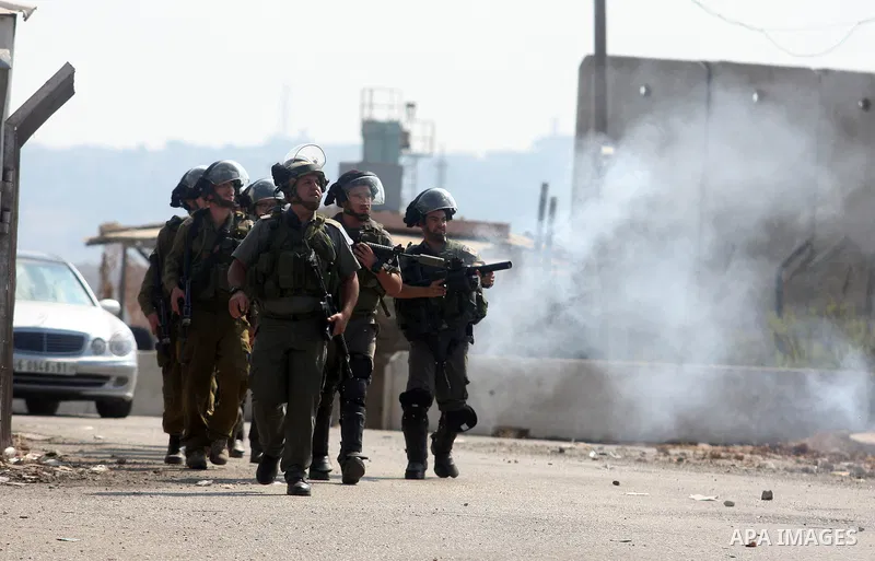Israeli border police fire tear gas during clashes with Palestinian protesters outside Israel's Ofer military prison, near the West Bank city of Ramallah, on October 10, 2012, following a demonstration to demand the rele...