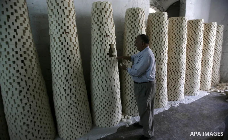 A Palestinian worker lines up soap pieces at the Touqan factory in the West Bank city of Nablus, on Oct. 11, 2012. The Touqan factory is one of the oldest manual factories in Nablus that manufactures the natural ''Nabuls...