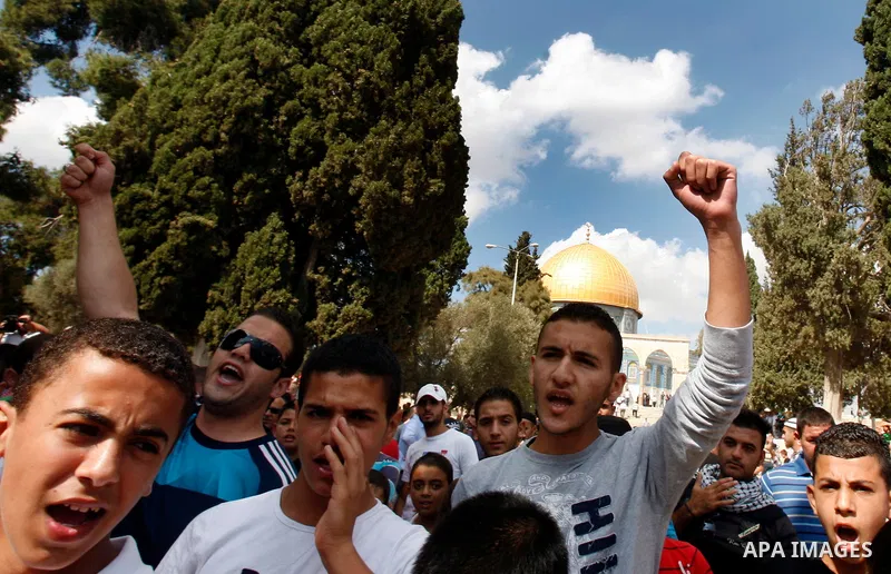 Palestinian protesters shout slogans during a demonstration after Friday prayers in front of the Dome of the Rock mosque at al-Aqsa mosque compound, Islam's third holiest site in Jerusalem's old city on Oct. 12, 2012. Ph...