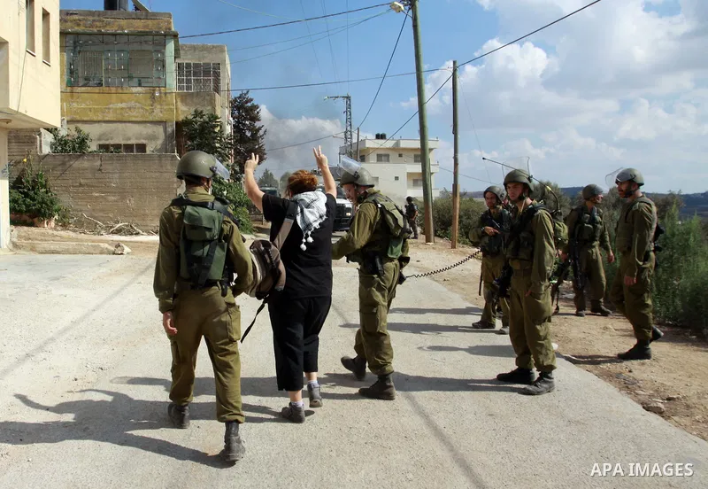 Israeli soldiers arrest an Israeli peace activist during clashes at a protest against the Jewish settlement of Qadomem, near Nablus, West Bank, 12 October 2012. Israeli troops arrested three protesters during the clashes...
