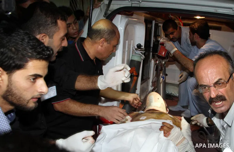 Palestinian medics check a wounded man at al-Shefa hospital in Gaza City following an Israeli airstrike in northern town of Jabaliya, in the Gaza Strip, on October 13, 2012. The air strike killed one Palestinian and woun...