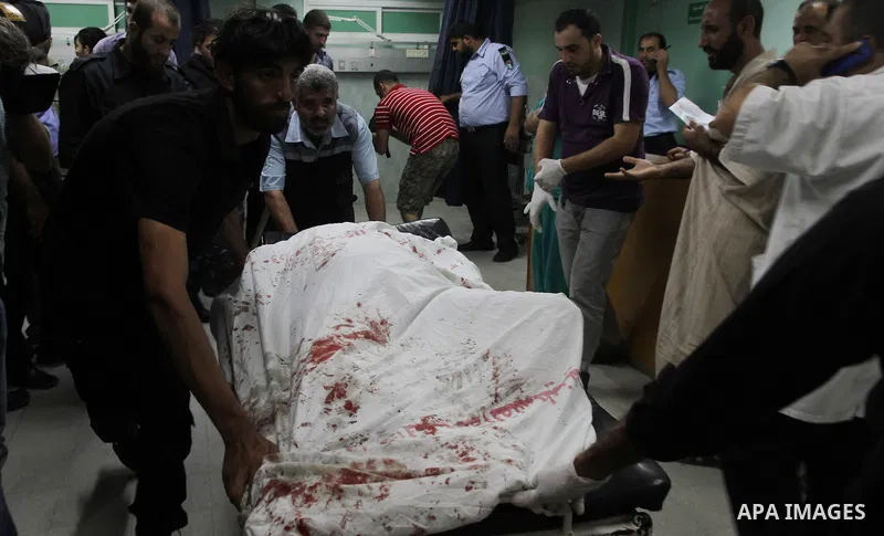 Palestinian medics check a wounded man at al-Shefa hospital in Gaza City following an Israeli airstrike in northern town of Jabaliya, in the Gaza Strip, on October 13, 2012. The air strike killed one Palestinian and woun...