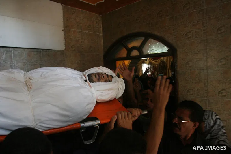 Palestinians carry the body of Yasser Al Attal during his funeral in Khan Younis, southern Gaza Strip,on October 14, 2012. An Israeli air strike Saturday on the Gaza Strip has killed the coastal enclave's main. Photo by...