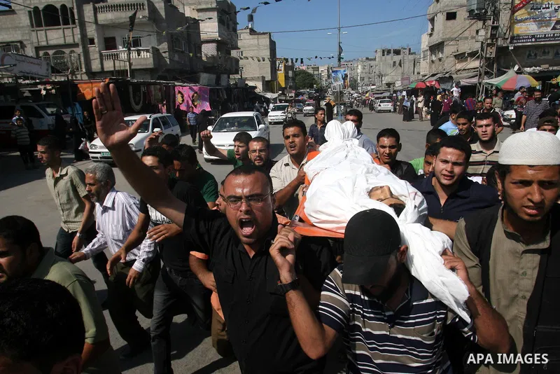 Palestinians carry the body of Yasser Al Attal during his funeral in Khan Younis, southern Gaza Strip,on October 14, 2012. An Israeli air strike Saturday on the Gaza Strip has killed the coastal enclave's main. Photo by...