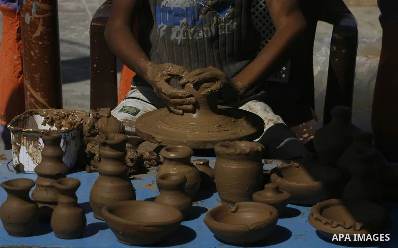 Palestinian boy, pots built with natural clay in Khan Younis in the southern Gaza Strip, on October 14, 2012. Photo by Eyad Al Baba