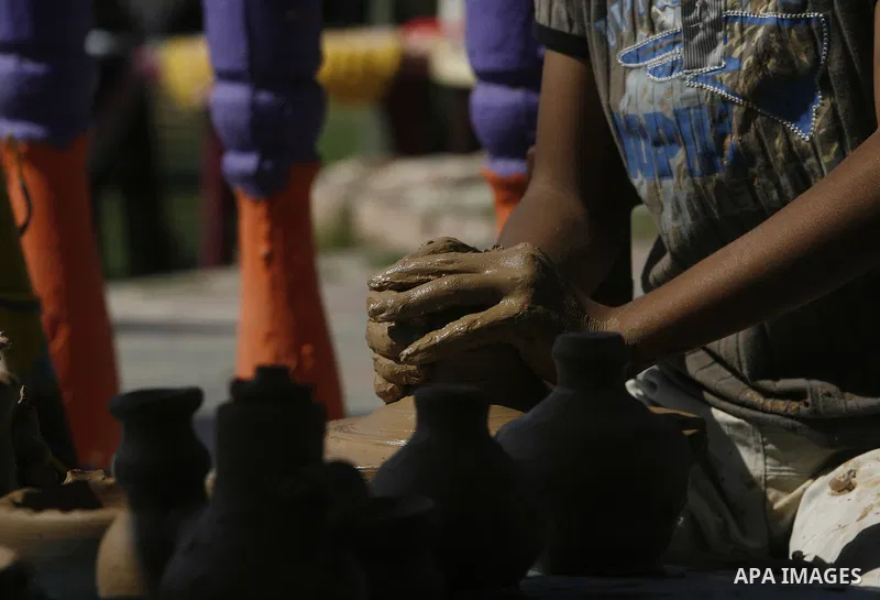 Palestinian boy, pots built with natural clay in Khan Younis in the southern Gaza Strip, on October 14, 2012. Photo by Eyad Al Baba