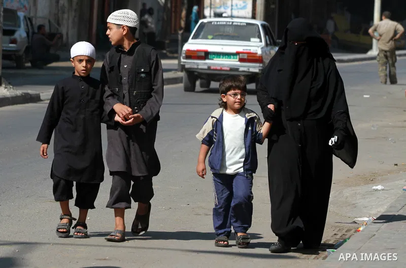 Palestinians walk during his funeral procession at Al-Bureij refugee camp in the central Gaza Strip, on October 14, 2012. Saedini, a top Salafist leader whose Islamist faction has recently fired rockets at Israel was amo...