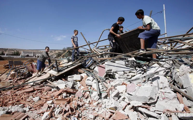 Palestinians inspect the damaged house that were built without a permit after it was demolished by an Israeli bulldozer, in the neighbourhood of Beit Hanina, in east Jerusalem, on Oct. 14, 2012. Israel regularly demolish...